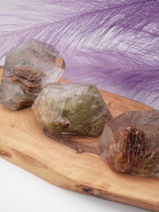 Three garden quartz freeforms on wooden display stand