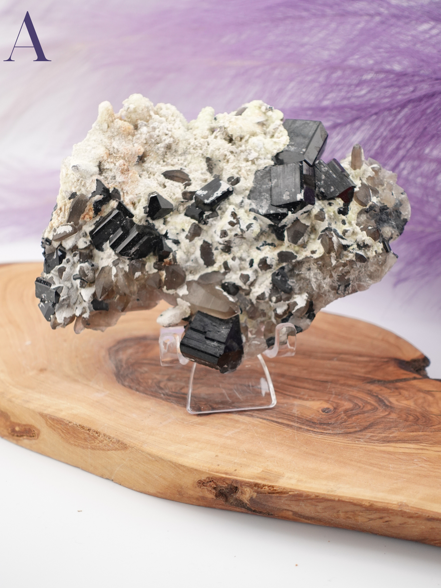 Option A black tourmaline, smoky quartz, and hyalite specimen on clear specimen stand.