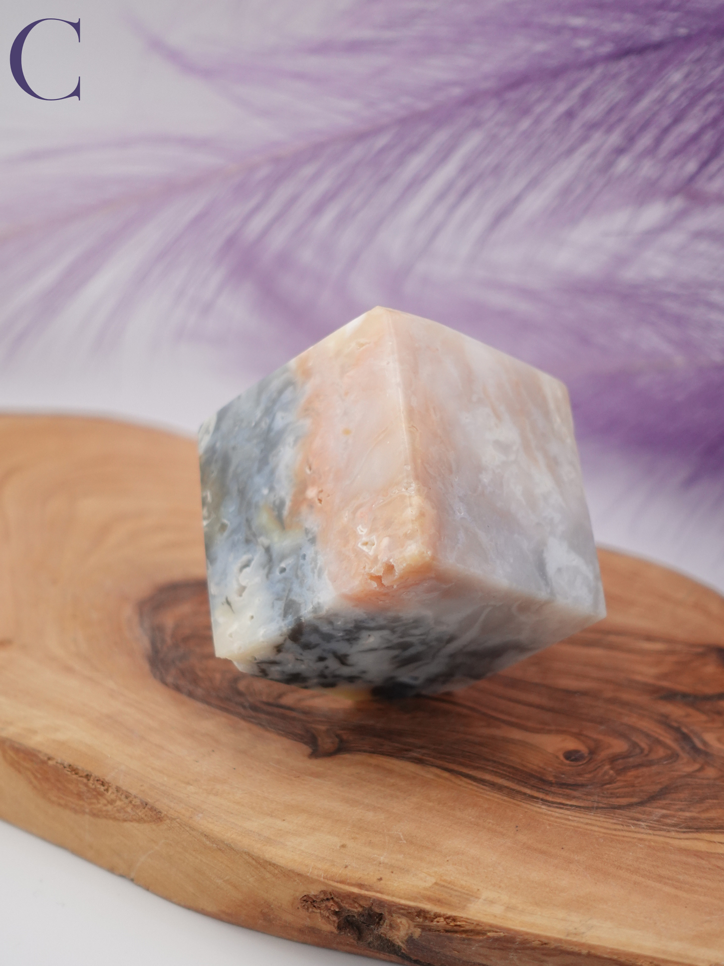 Rainbow plume agate floating cube option C on wooden display stand