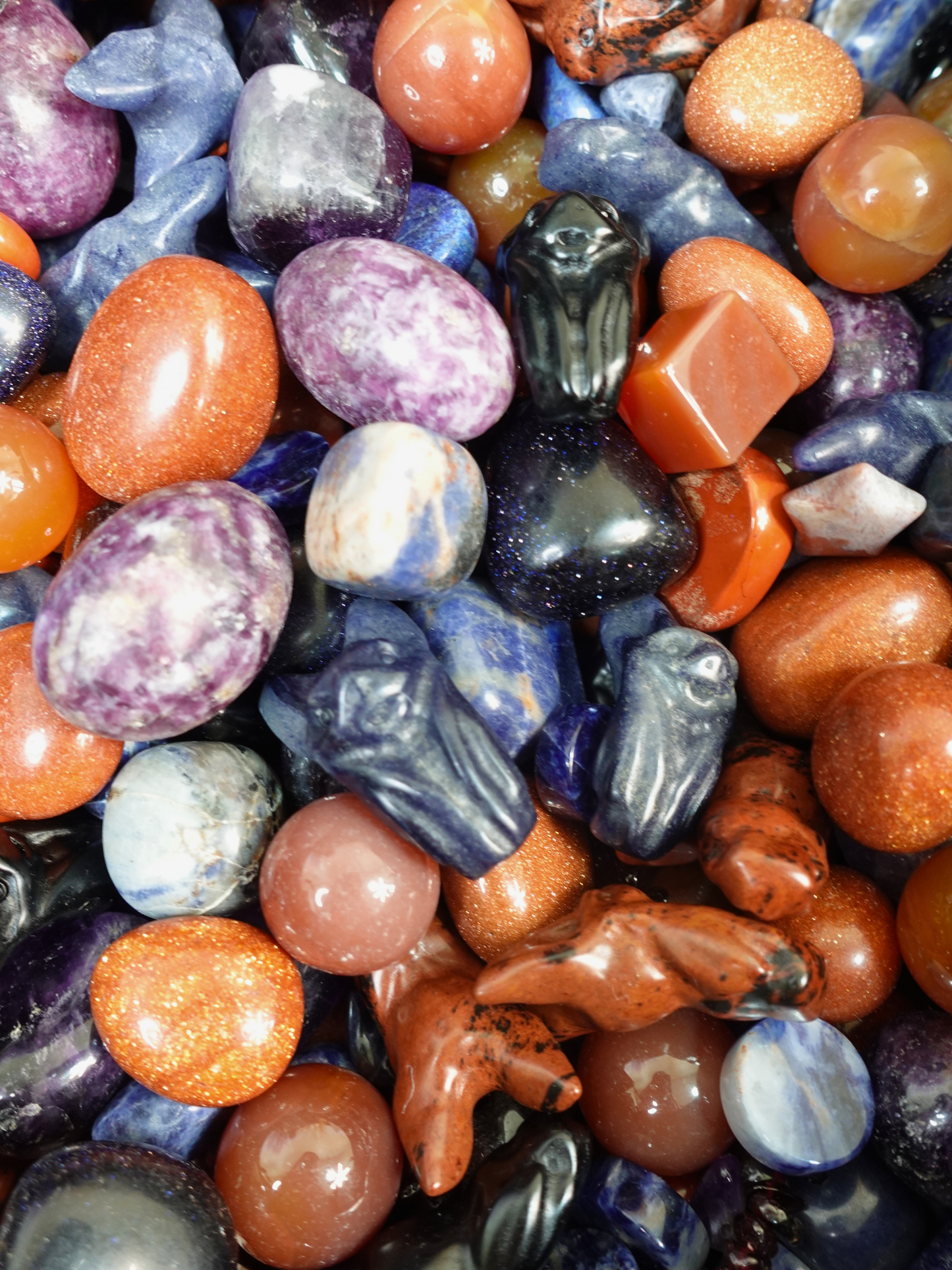Variety of crystal tumbles, carvings, flat stones, and mini spheres.