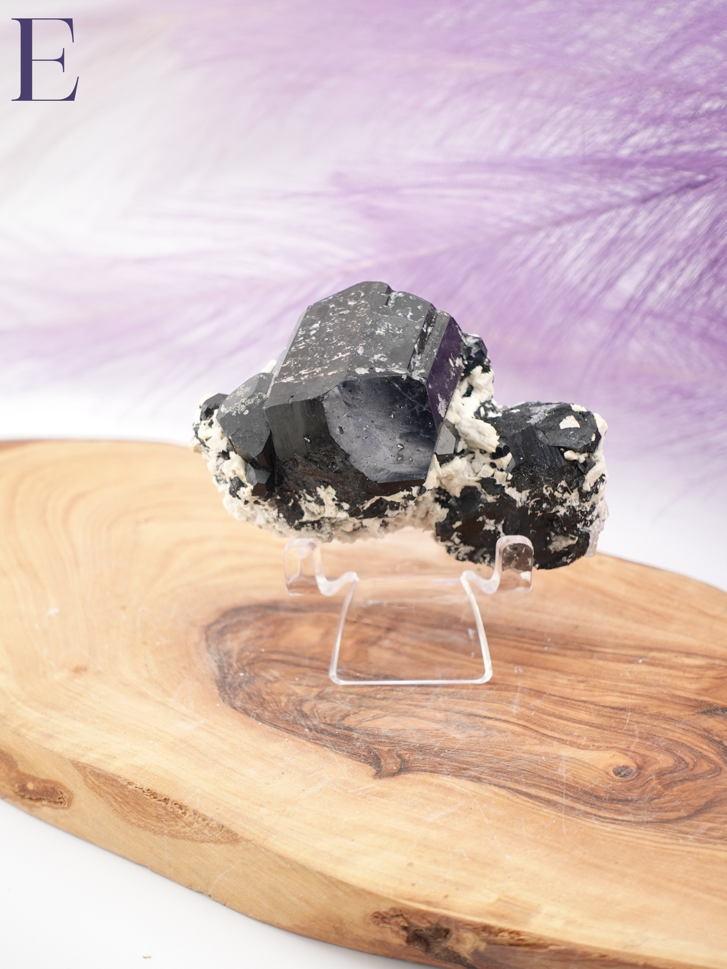 Option E black tourmaline, smoky quartz, and hyalite specimen on clear specimen stand.