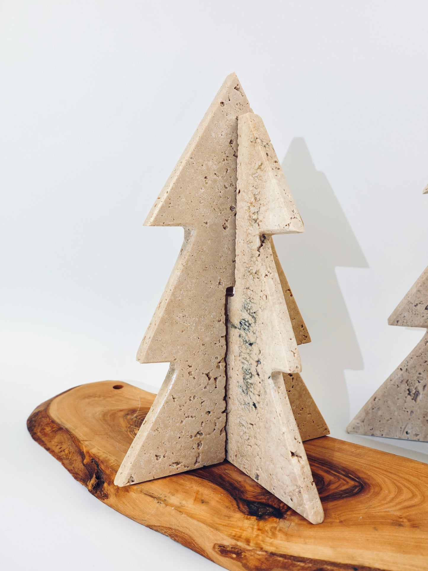 Decorative concrete Christmas tree on a wooden base with a white background