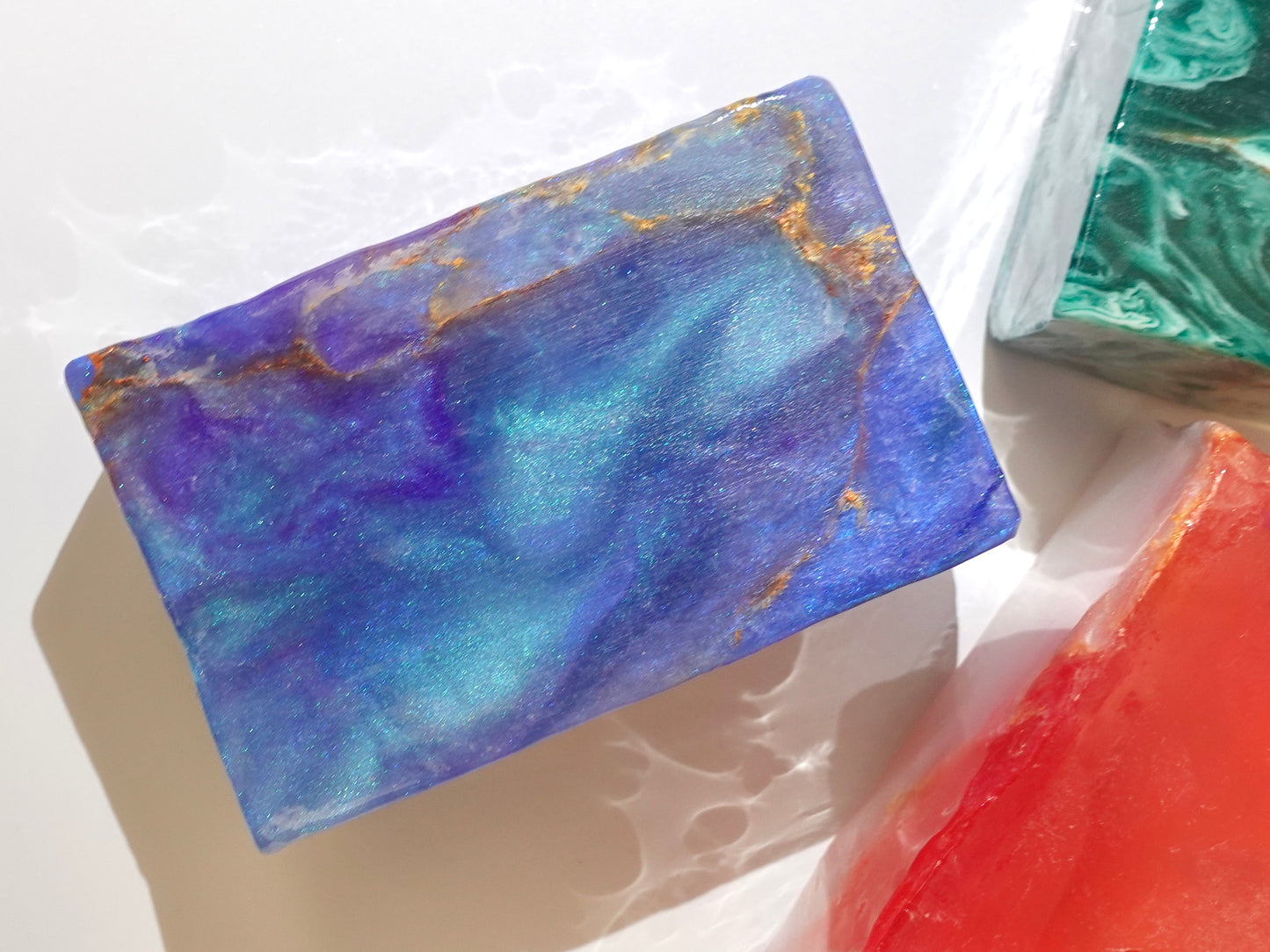 Colorful marbled soap bars on a light background