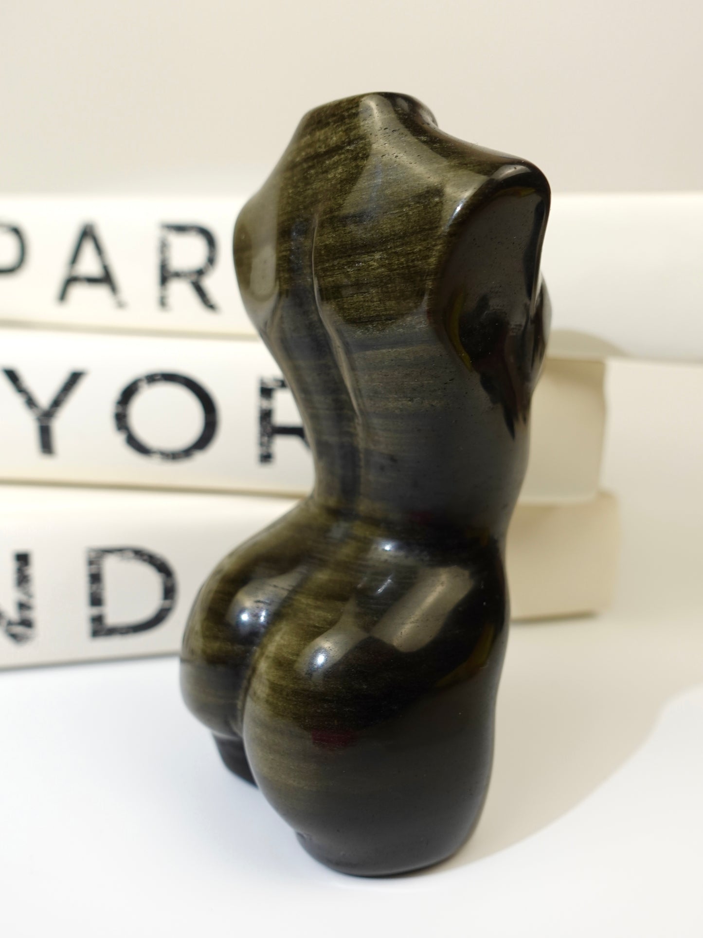 Gold sheen obsidian goddess body with books in the background