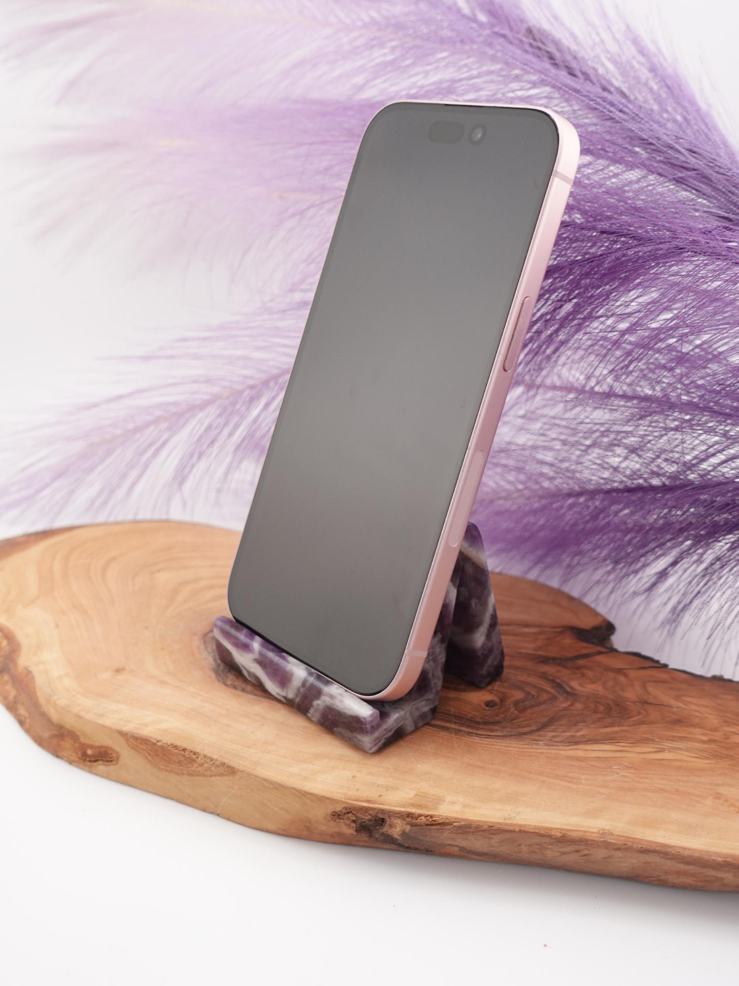 Dream amethyst phone holder holding a phone on wooden display stand