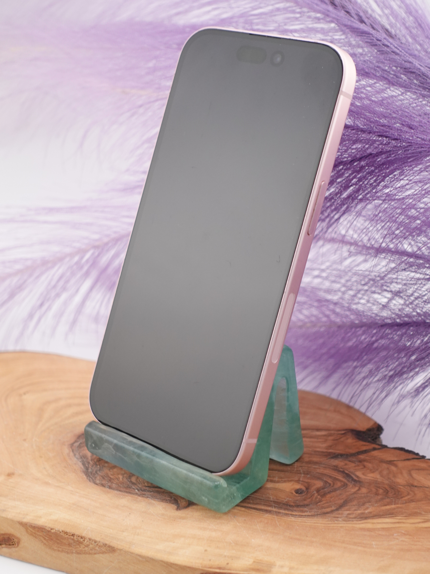 Fluorite phone holder holding a phone on wooden display stand