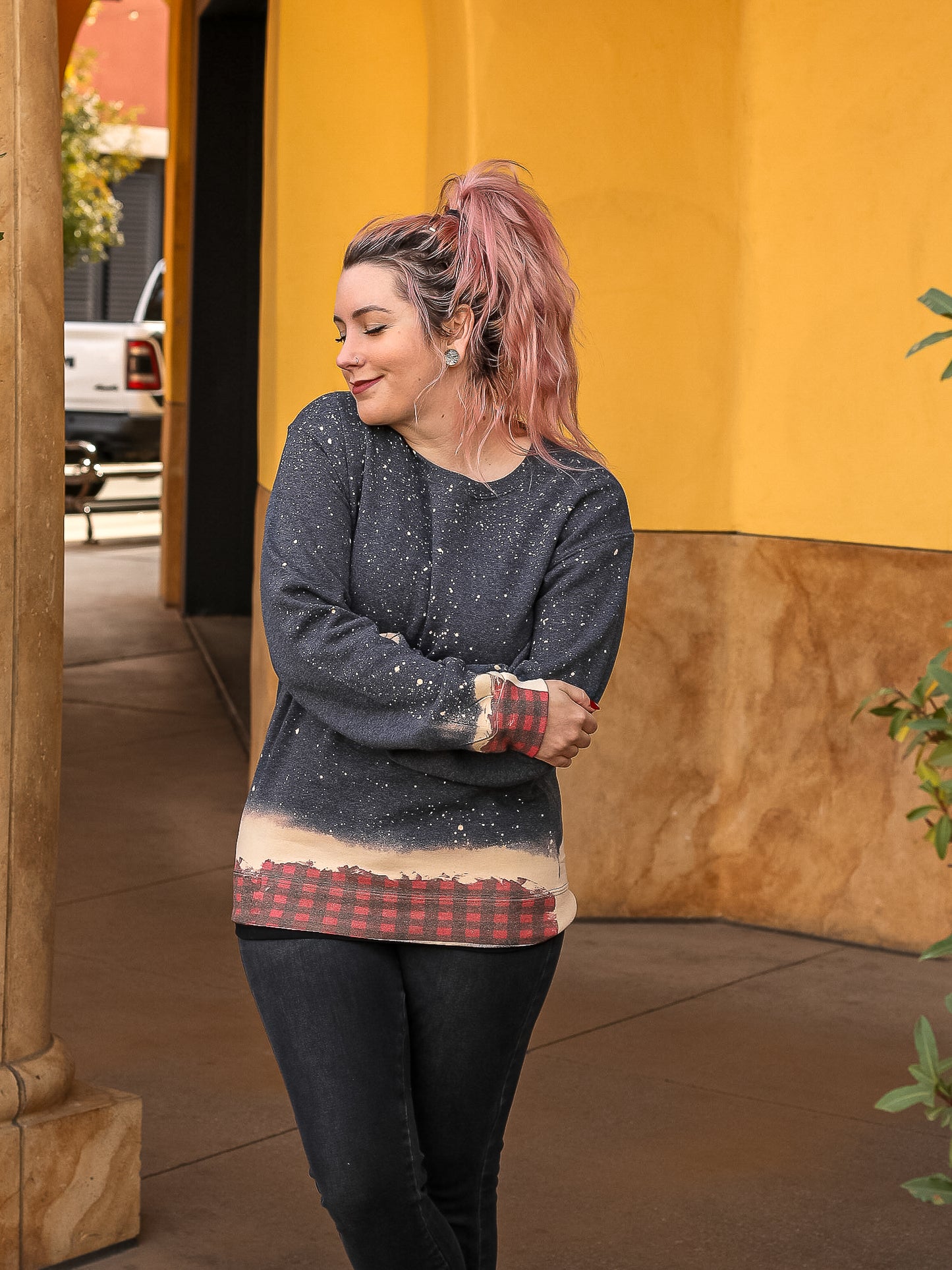 Grey bleached sweater with dip dye of buffalo plaid across the bottom and wrists.