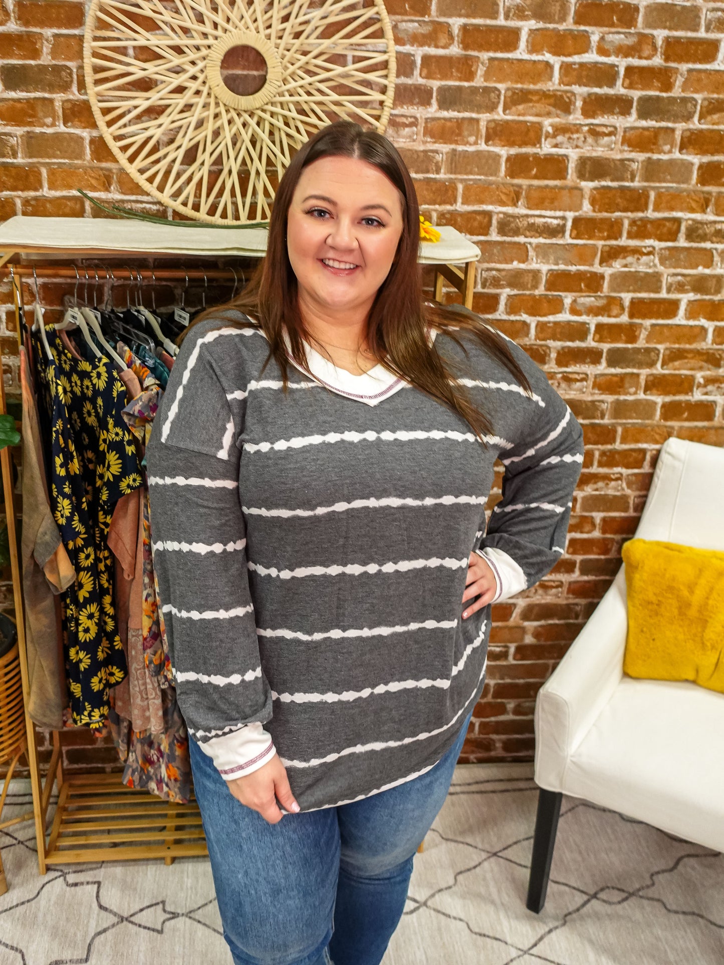 Grey long sleeve top with white tie dye stripes and white trim details.