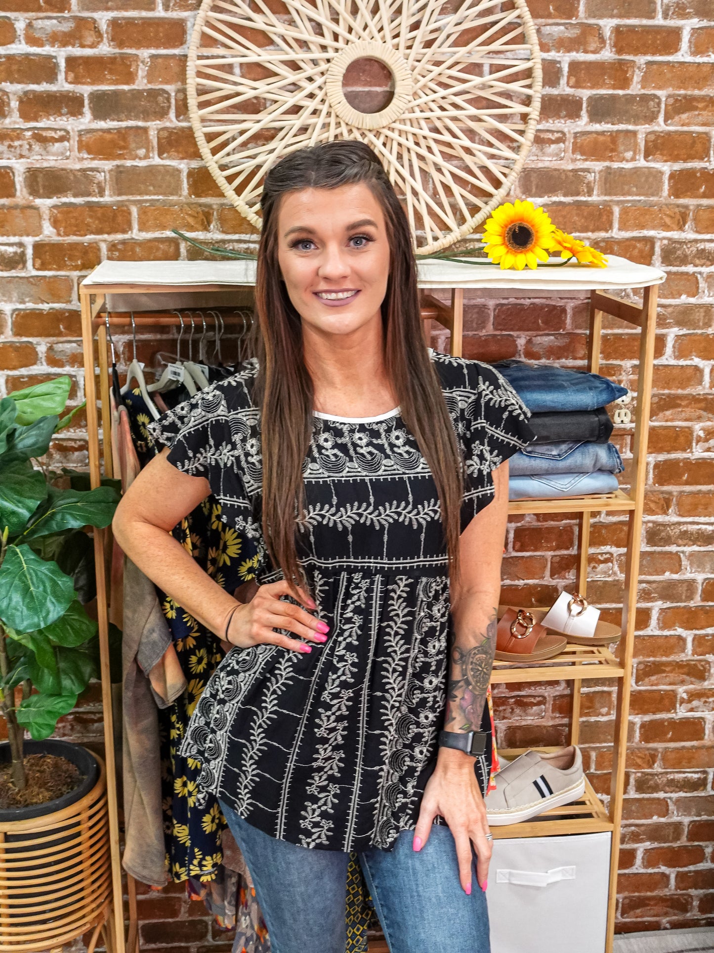 Black babydoll top with floral details and short bell sleeves