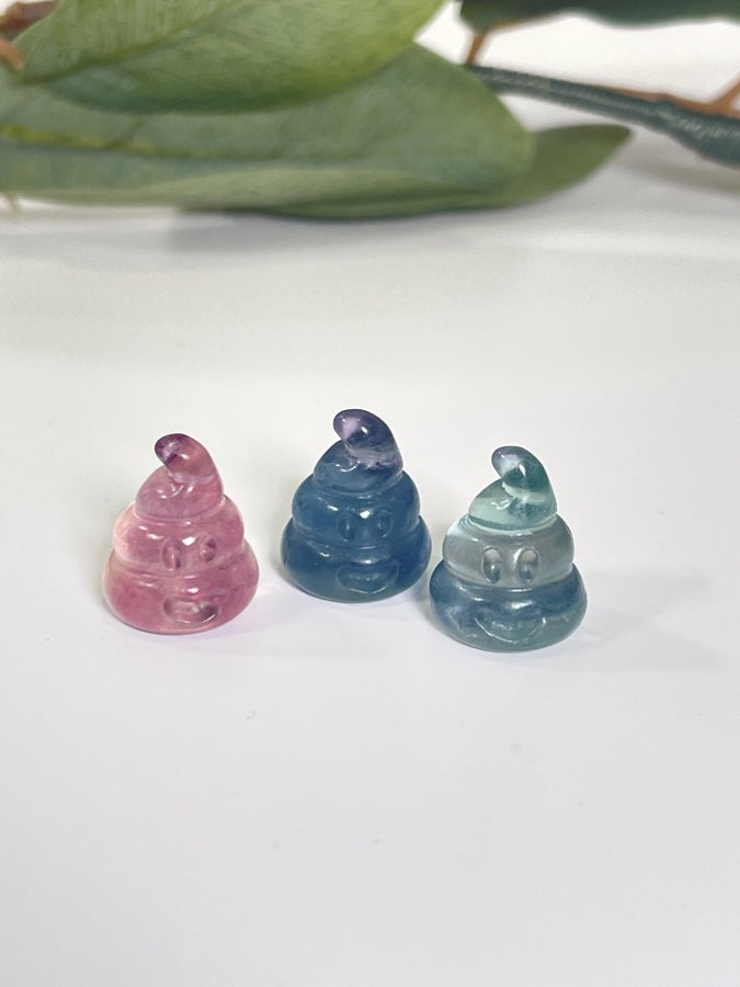 Three poop emoji carvings in fluorite