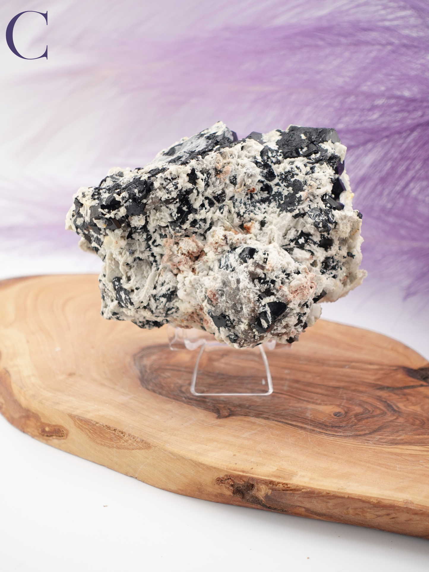 Option C black tourmaline, smoky quartz, and hyalite specimen on clear specimen stand.