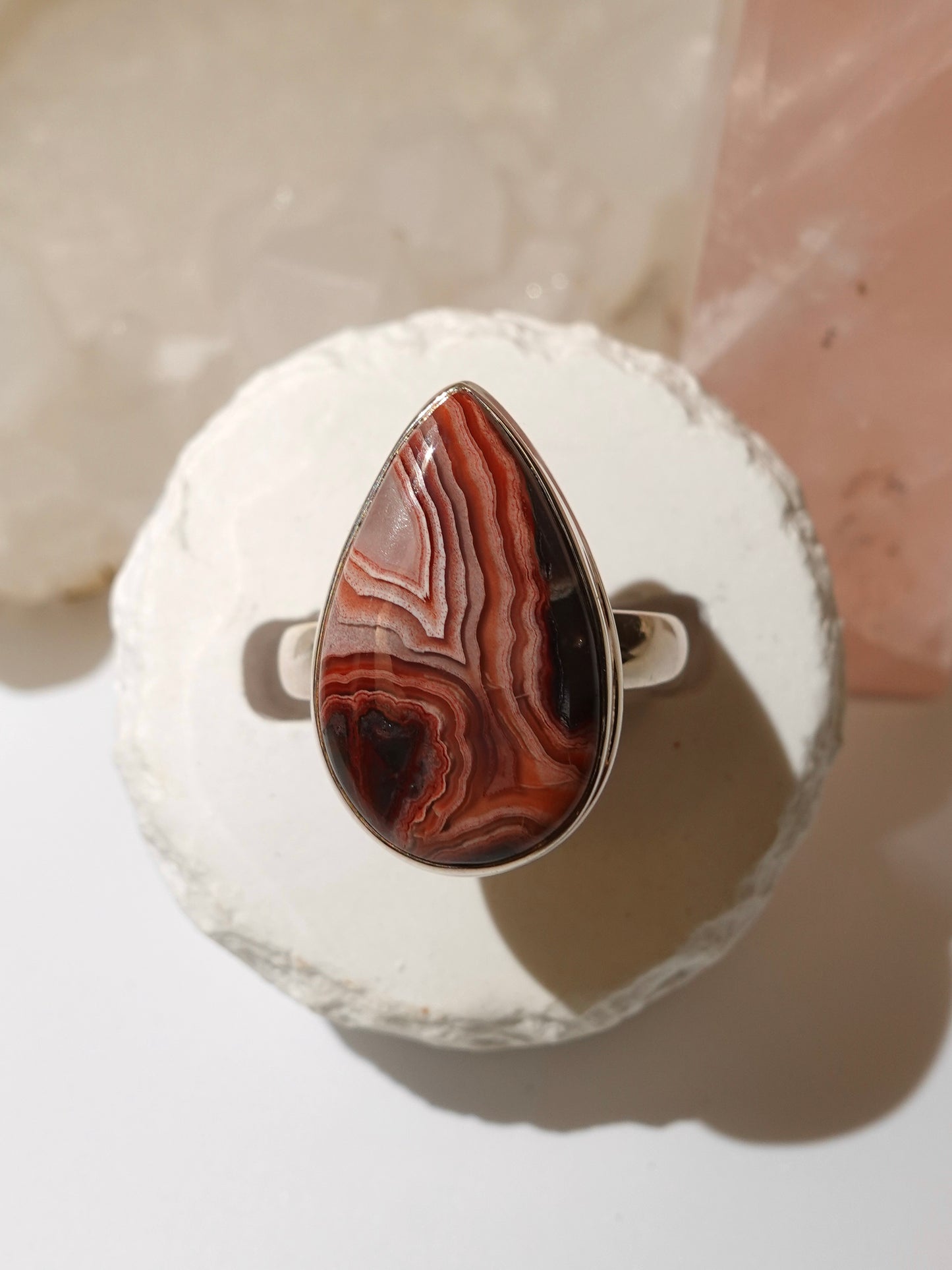 Mexican Crazy Lace ring on stand with pink crystal background