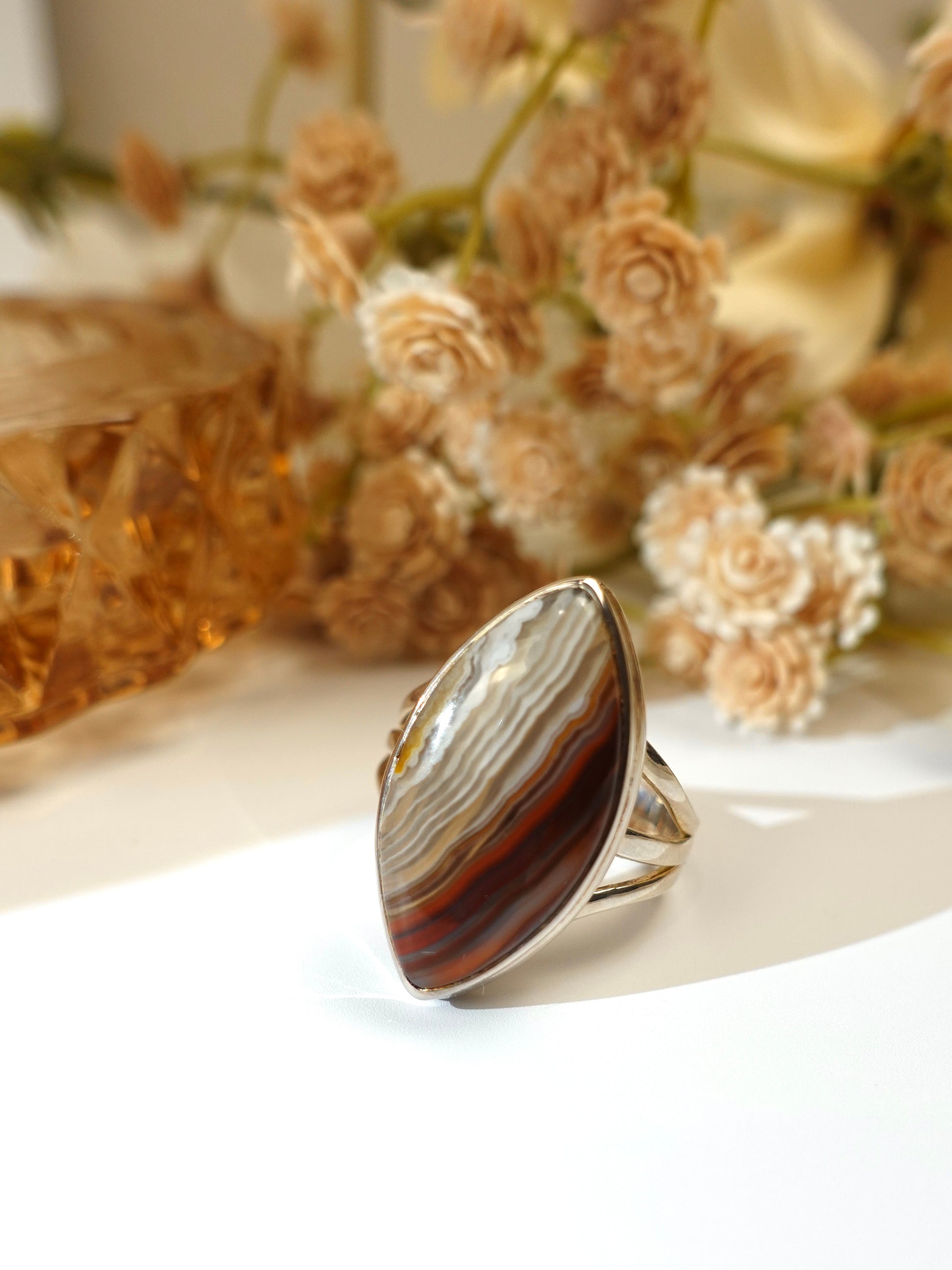 laguna agate ring with decorative flowers in the background