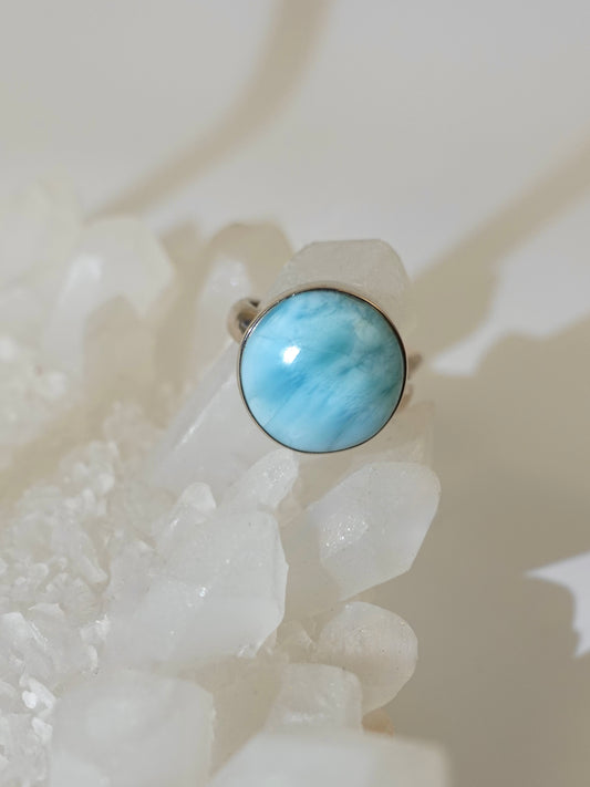 Larimar ring on crystal display with white background