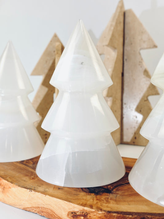 White tree-shaped objects on a wooden surface with a neutral background