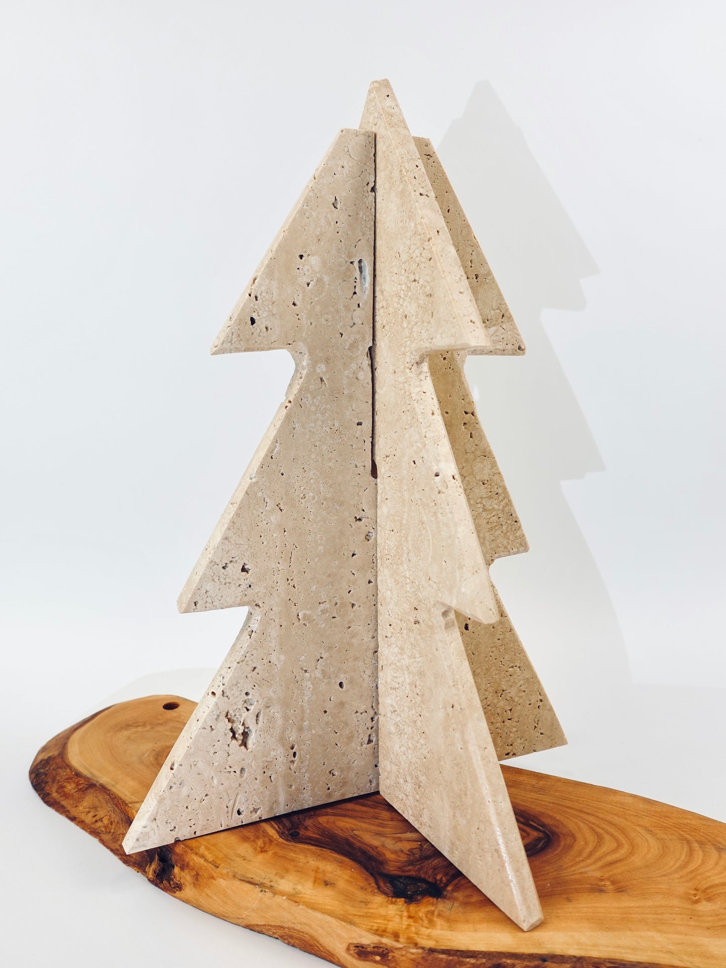 Concrete Christmas tree decoration on a wooden base with a white background