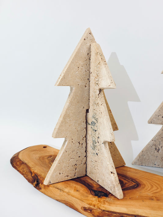 Decorative concrete Christmas tree on a wooden base with a white background