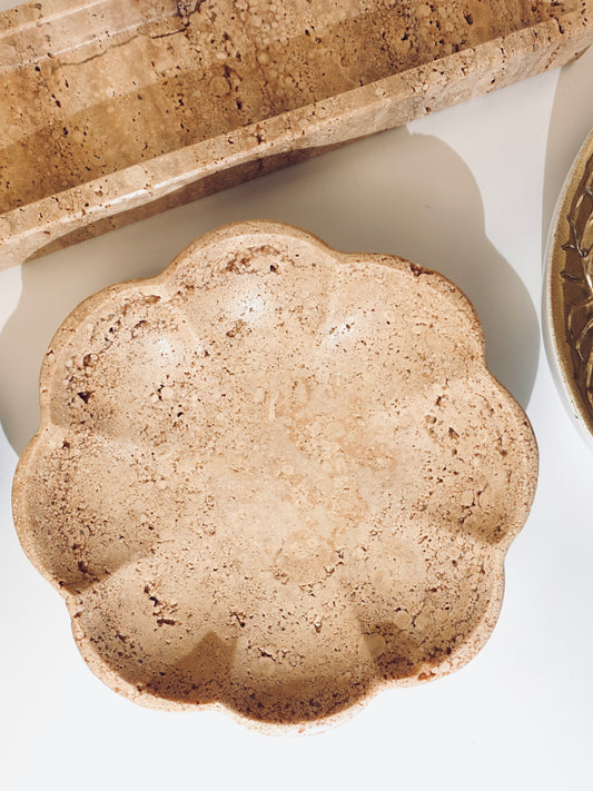 Scalloped travertine dish on white background