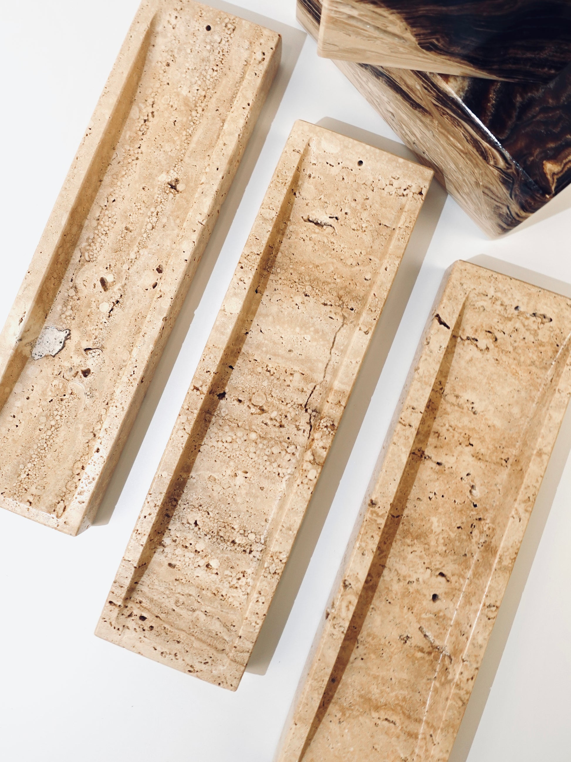 travertine incense holders on white background