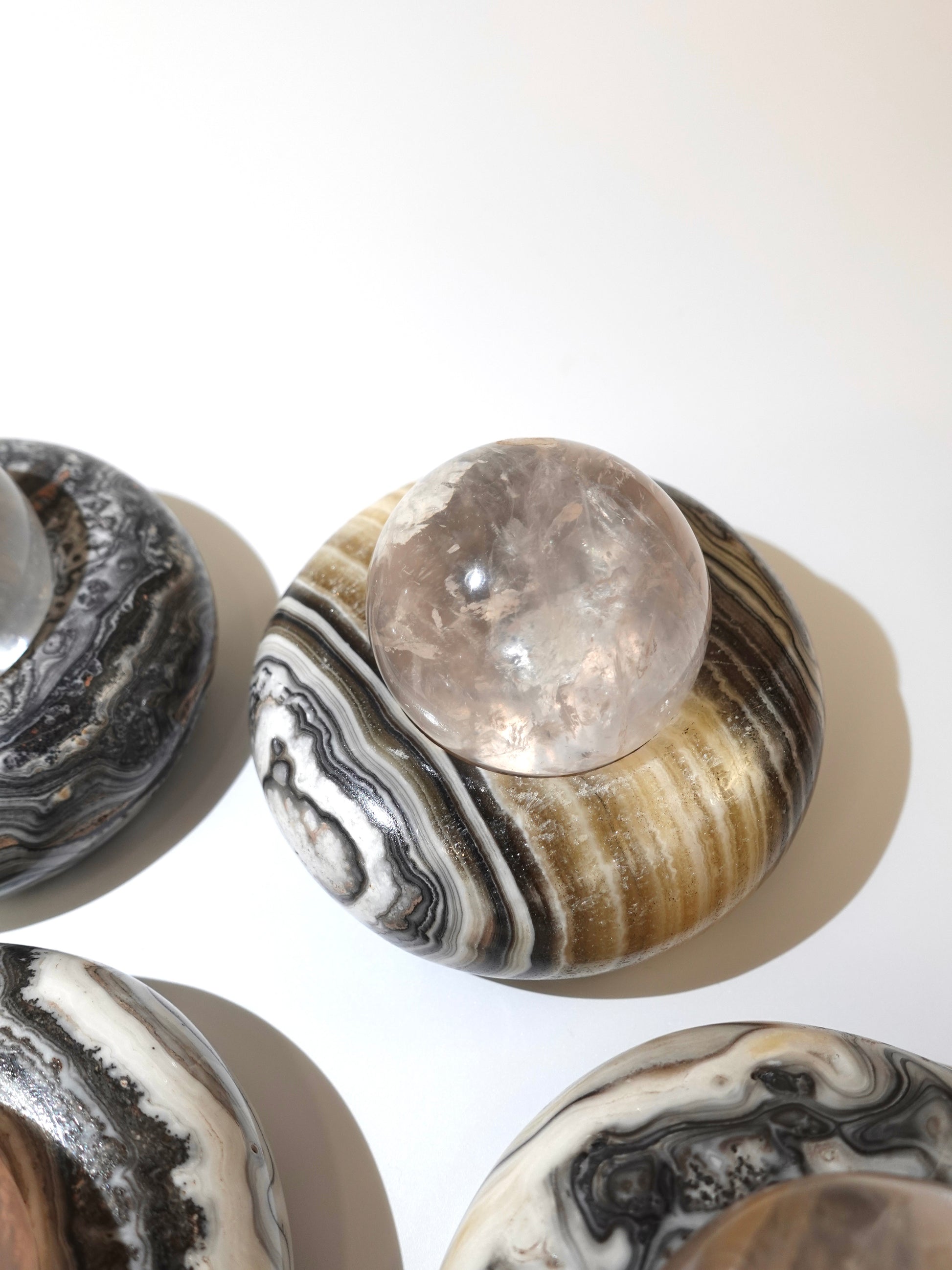 zebra calcite candle or sphere holder with sphere on top on white background
