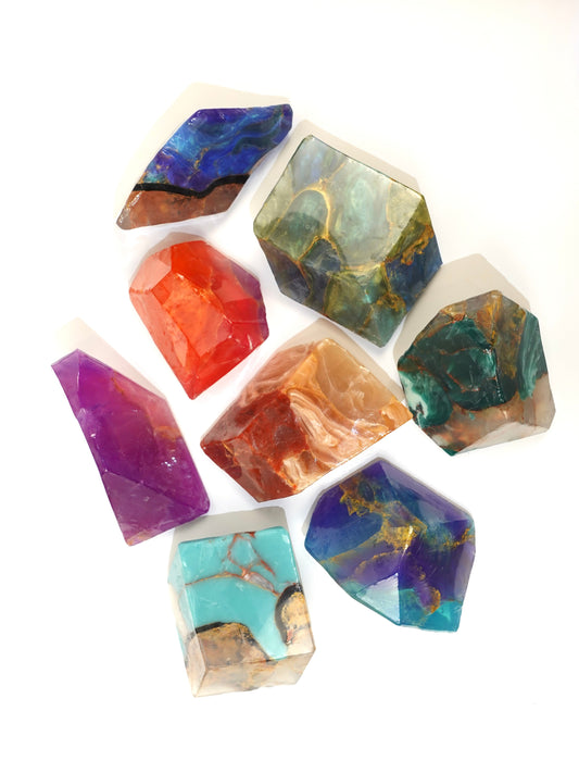 Colorful crystal inspired soaps on a white background