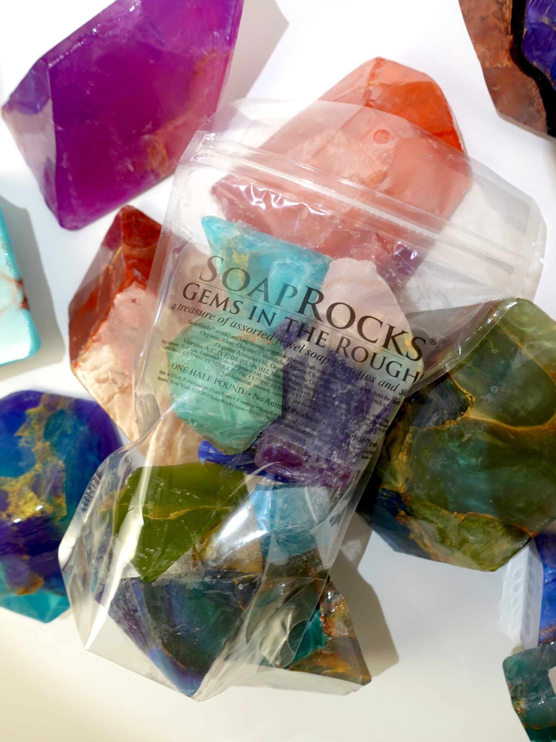 Bag of Soap Rocks with colorful soap rocks on a white background