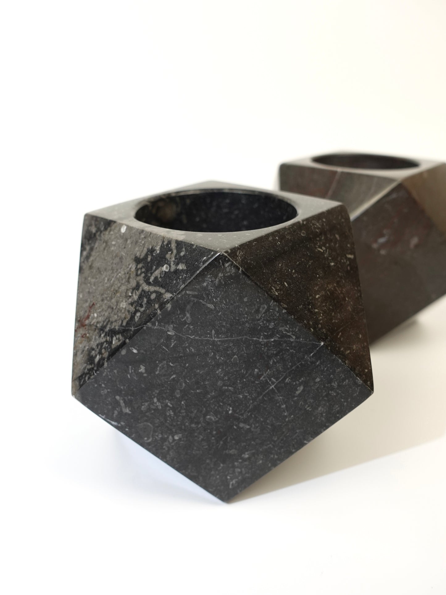 Two geometric marble holders on a white background