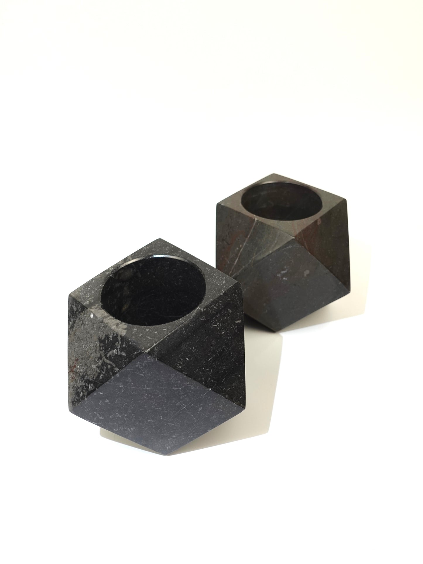 Two geometric marble holders on a white background
