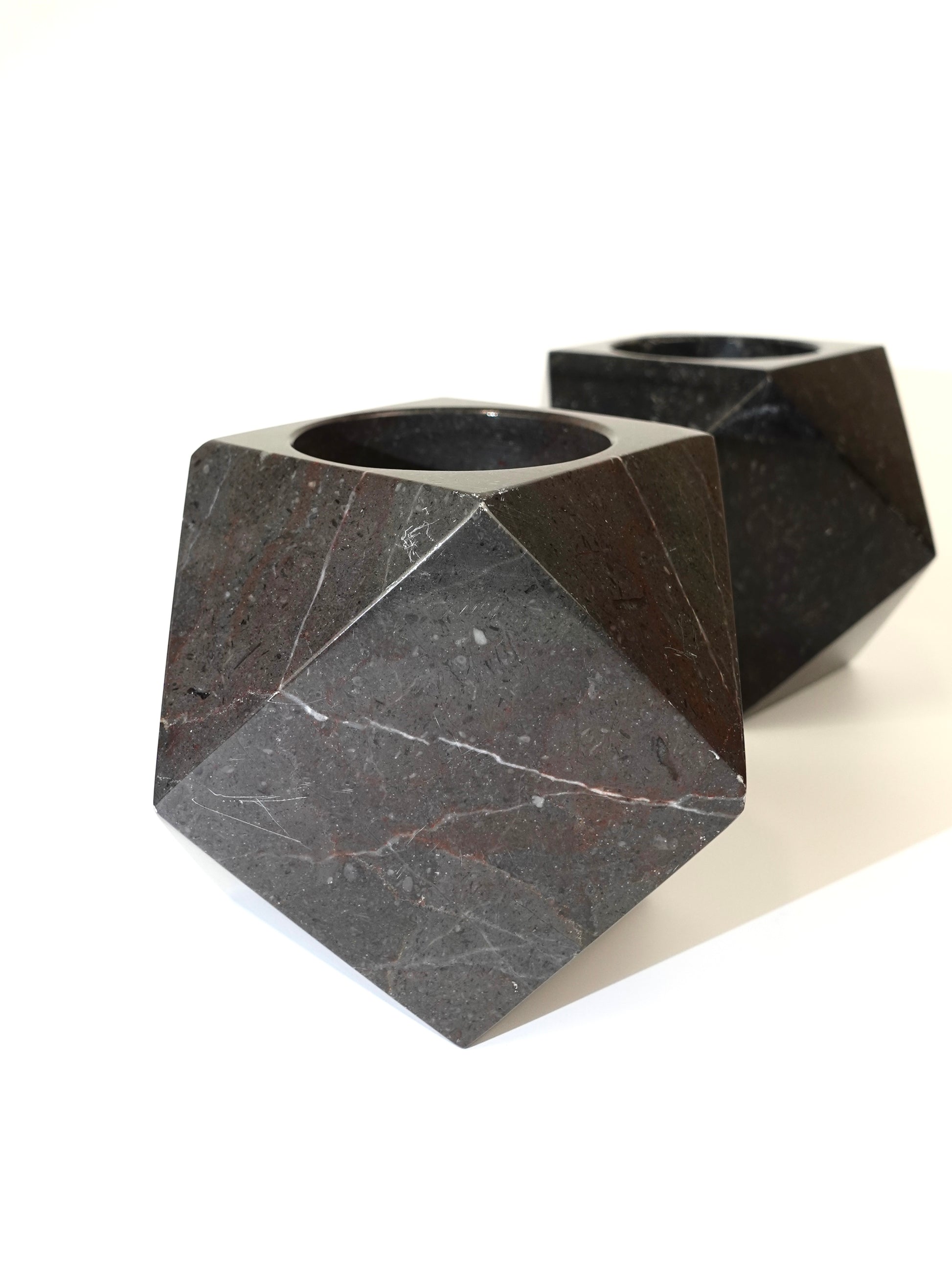 Two geometric marble holders on a white background