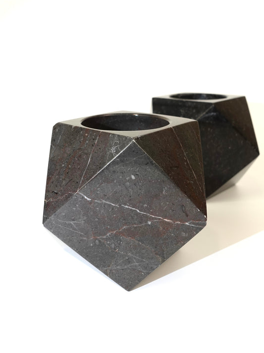 Two geometric marble holders on a white background