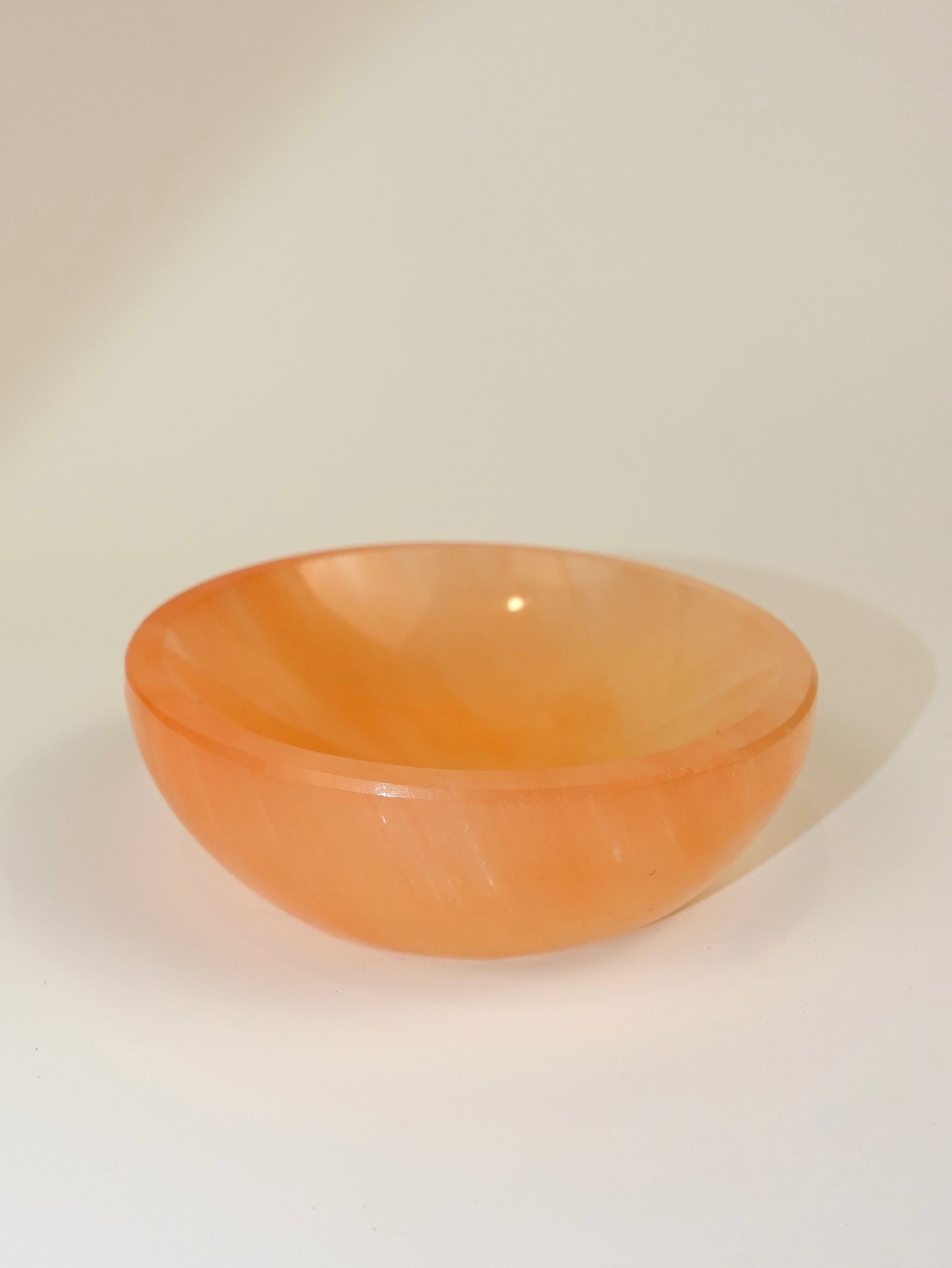 Peach Selenite bowl on white background