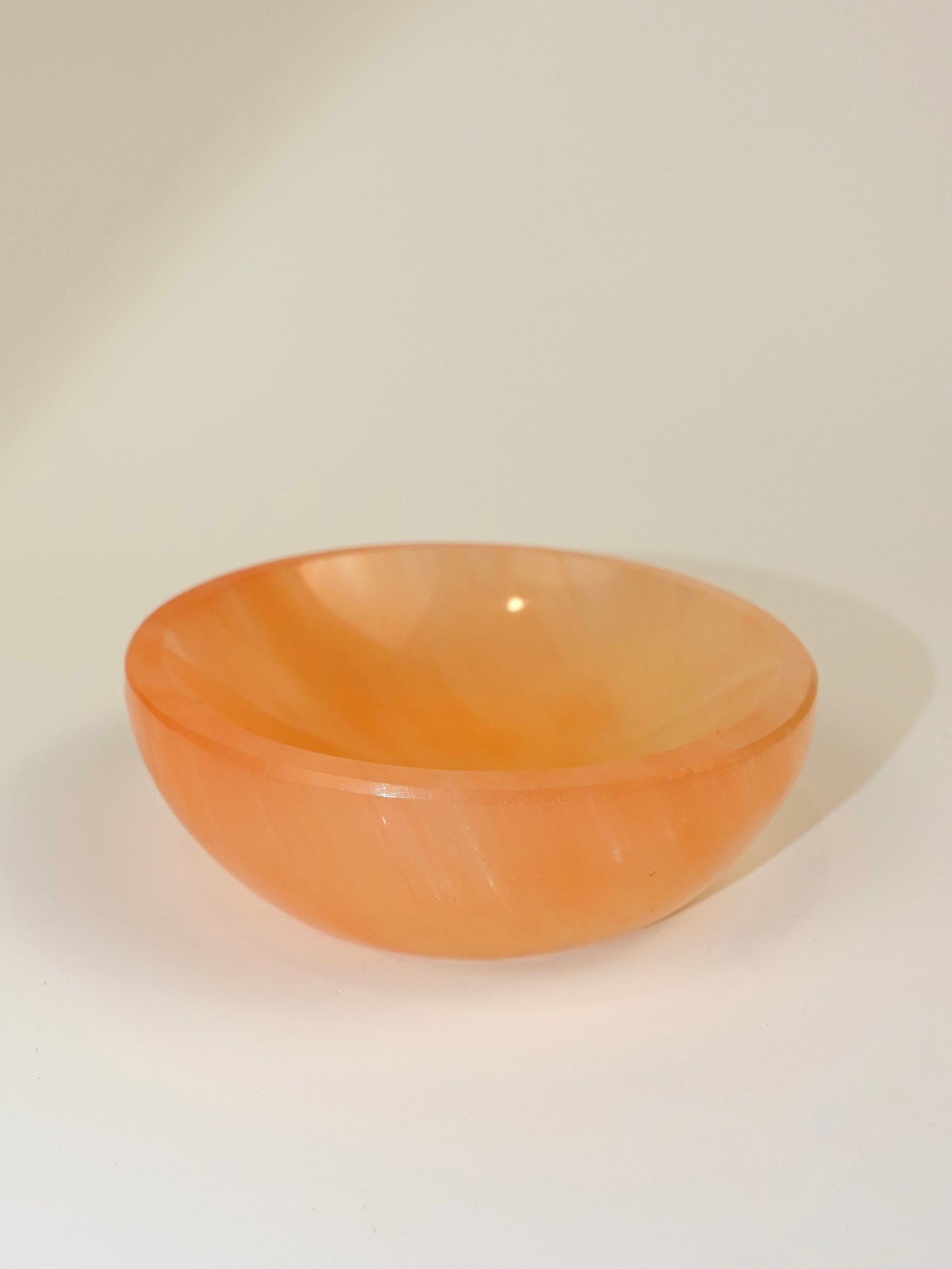 Peach Selenite bowl on white background