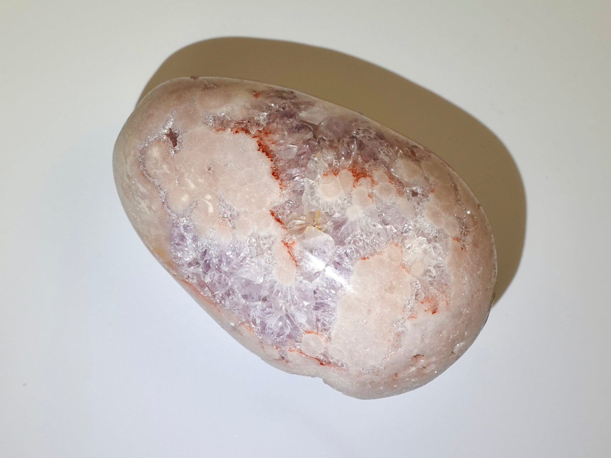 pink amethyst egg on white background