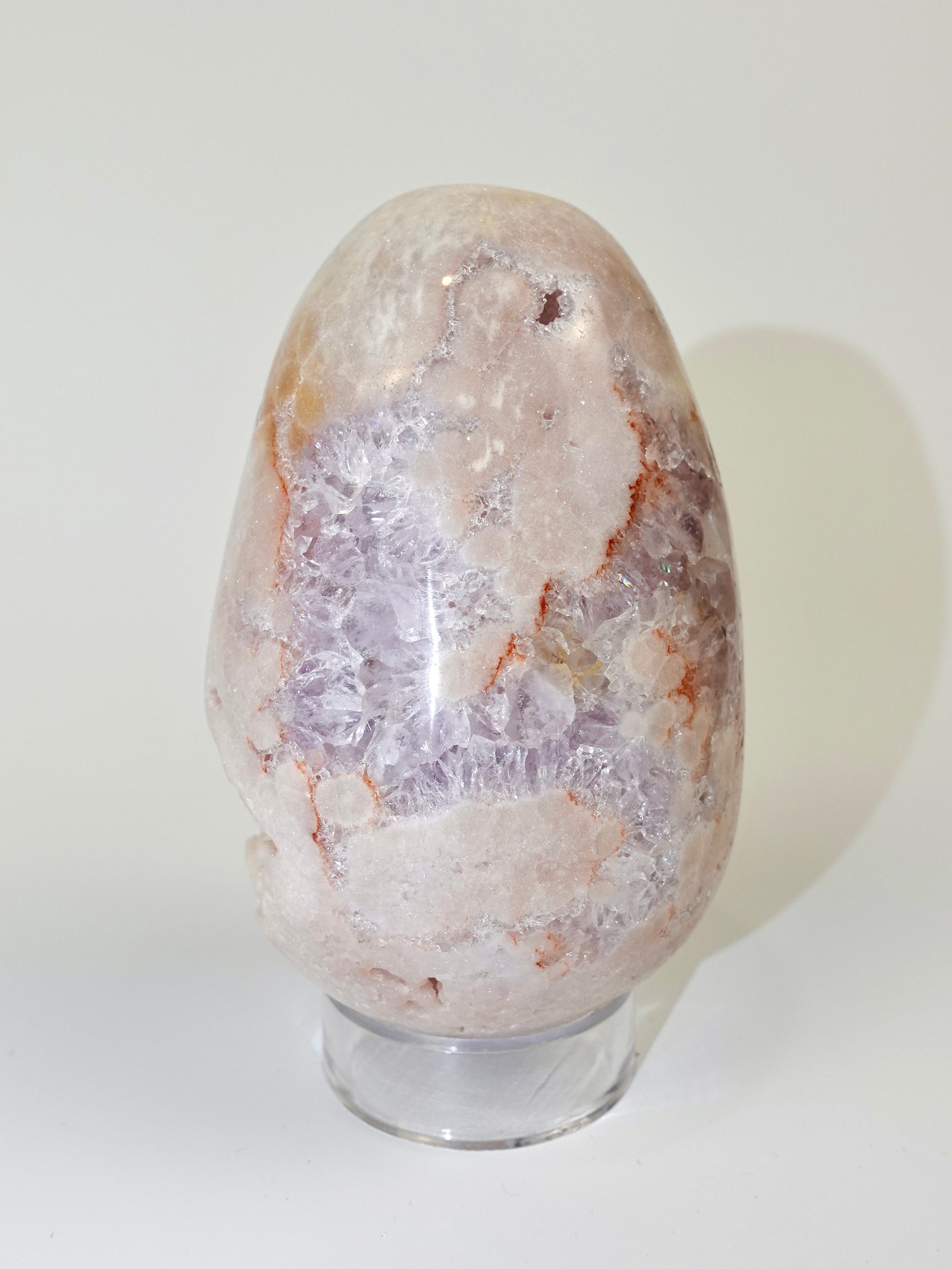 Pink amethyst egg on white background