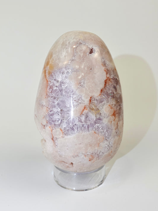 Pink amethyst egg on white background