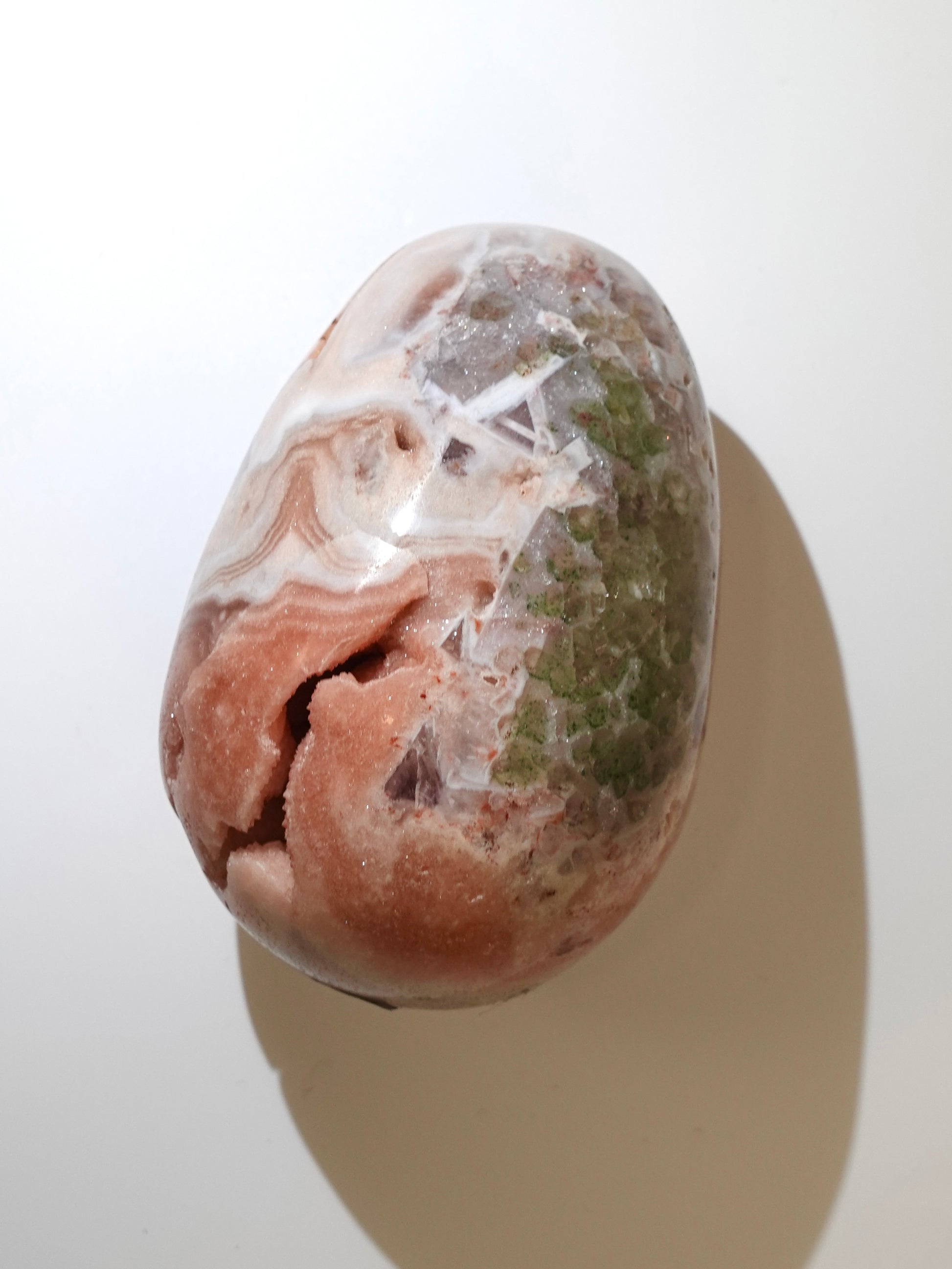 pink amethyst egg on white background