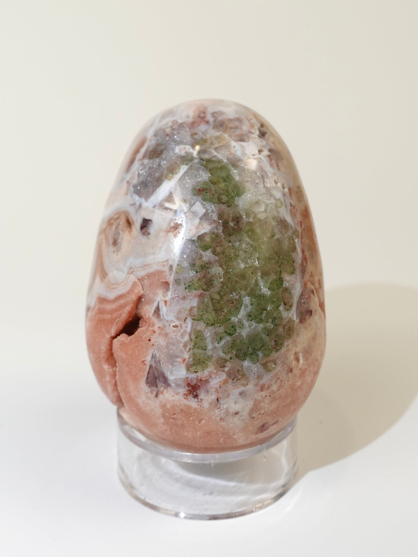 Pink amethyst egg on white background