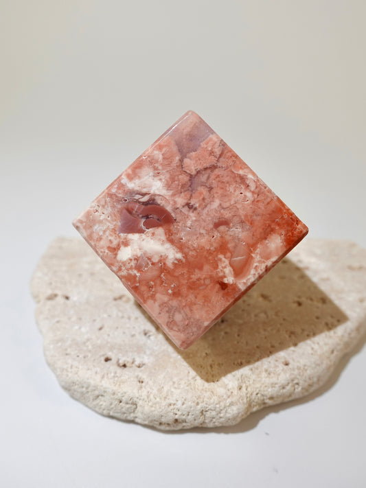 Pink Agate Floating Cube Option A on travertine display and white background