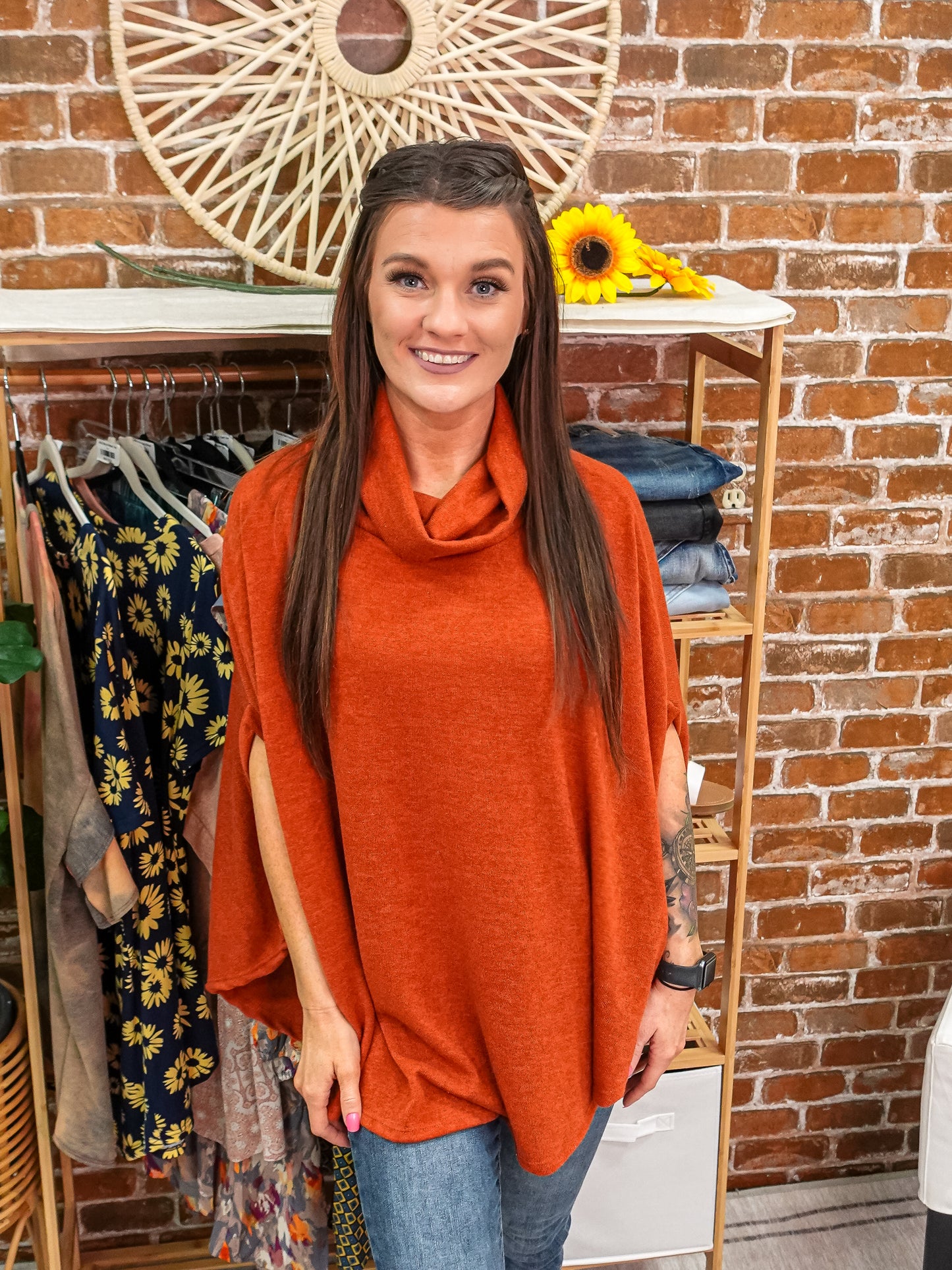 Orange poncho with loose turtle neck and rounded him. 