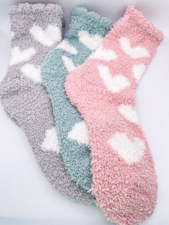 Three fuzzy socks with white heart details