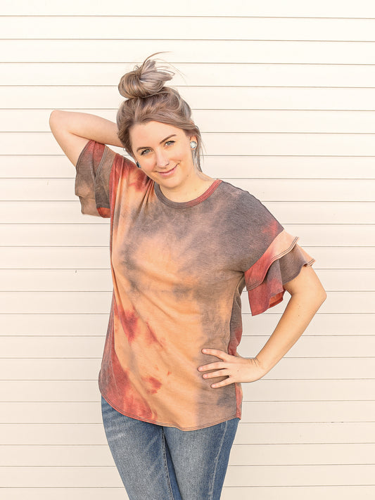 Rust and violet tie-dye short sleeve with ruffled top. 