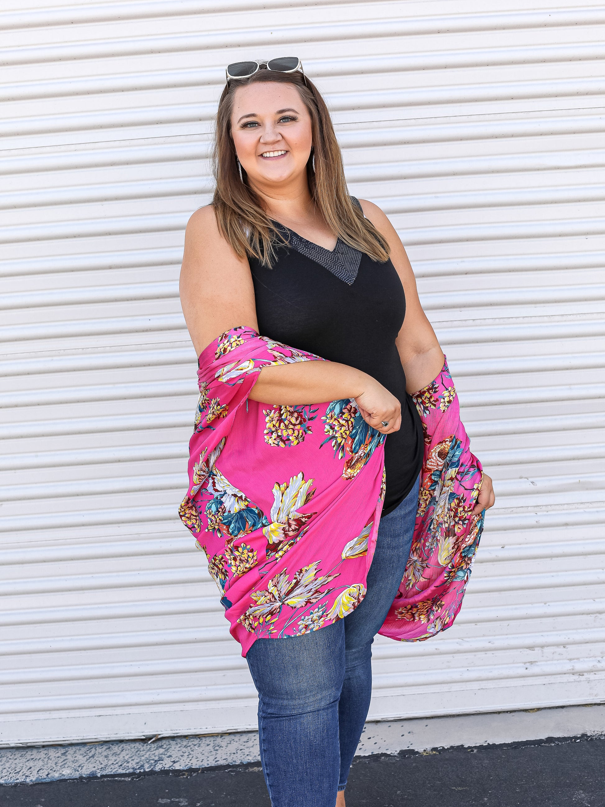 Black tank top with sequin v-neck line styled under a pink floral kimono.