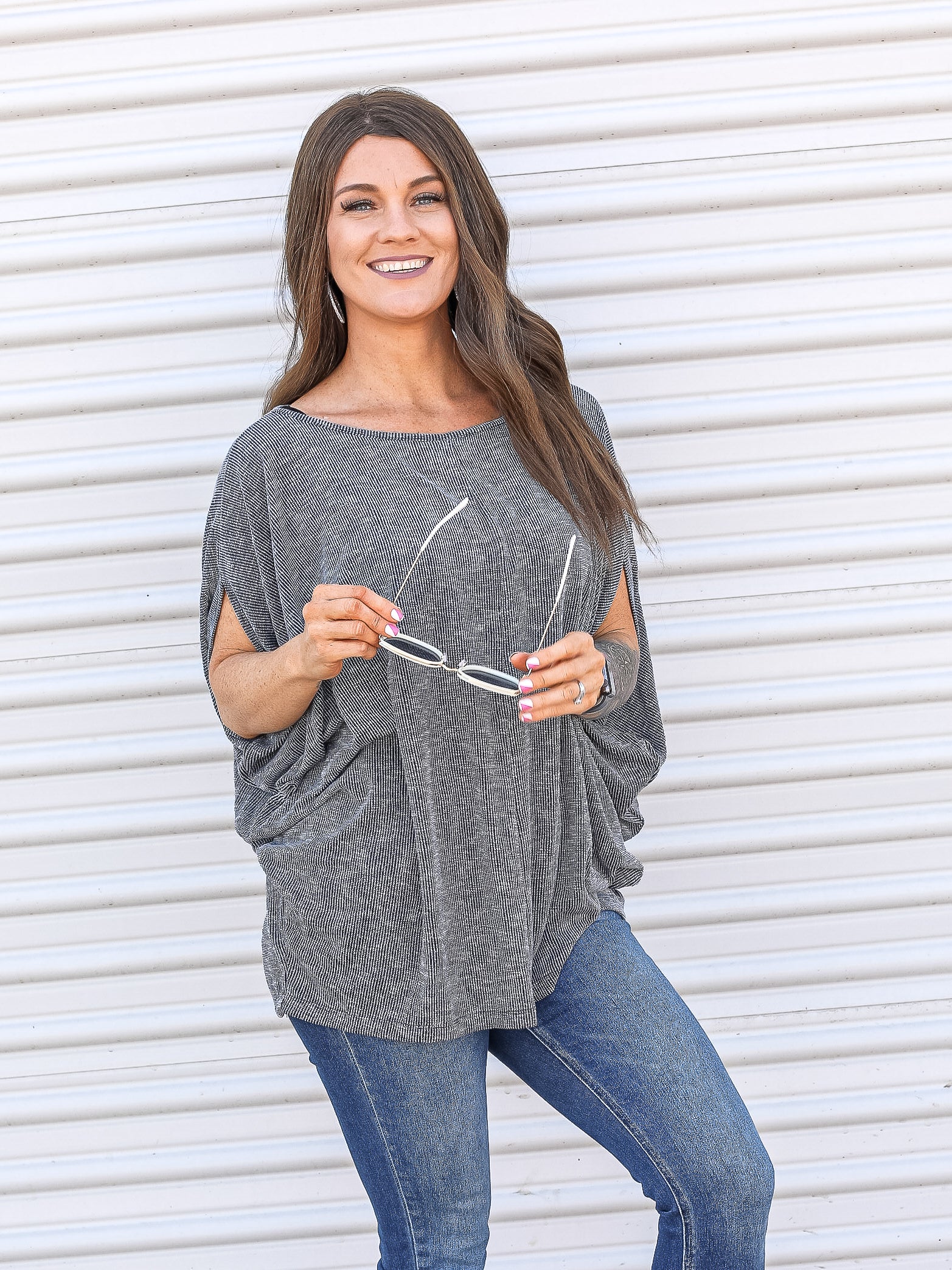 Heathered grey dolman top with short sleeves and rounded hem