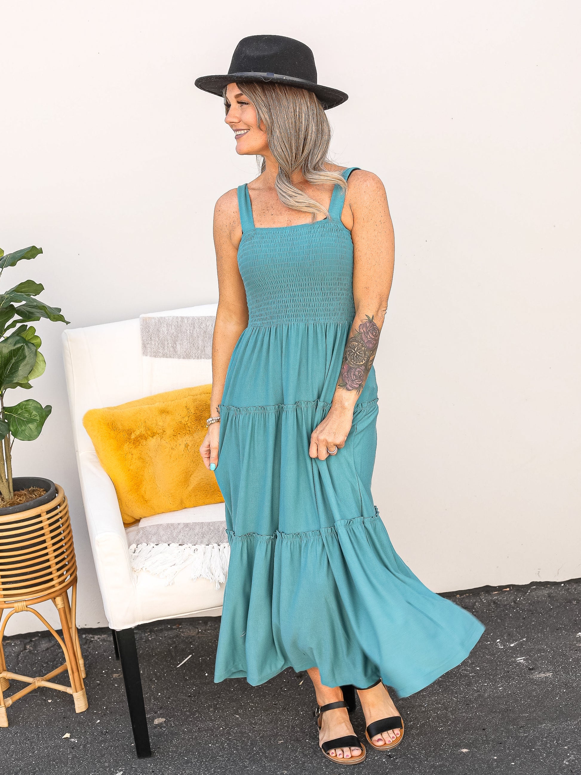 Teal colored midi sleeveless dress with smocking at the top.