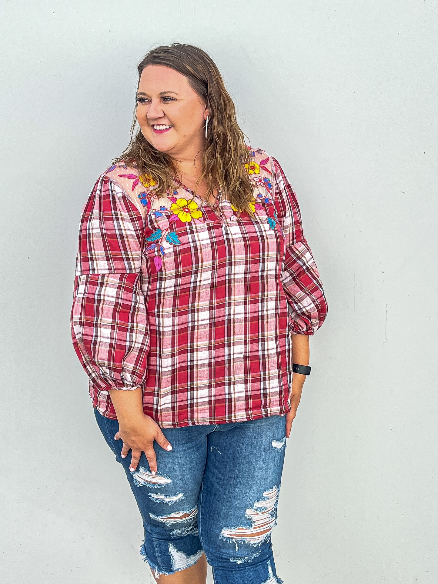 Side angle of red plaid top with balloon three quarter sleeves