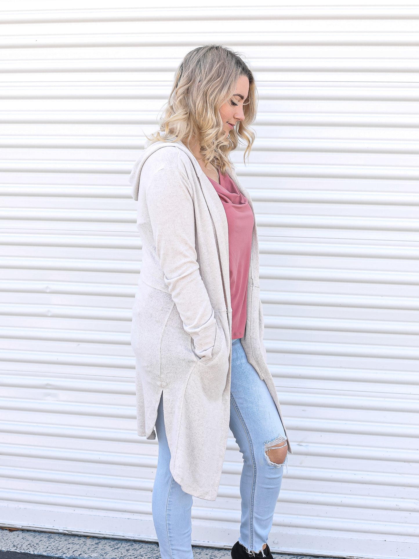 Side view of the oatmeal colored open cardigan