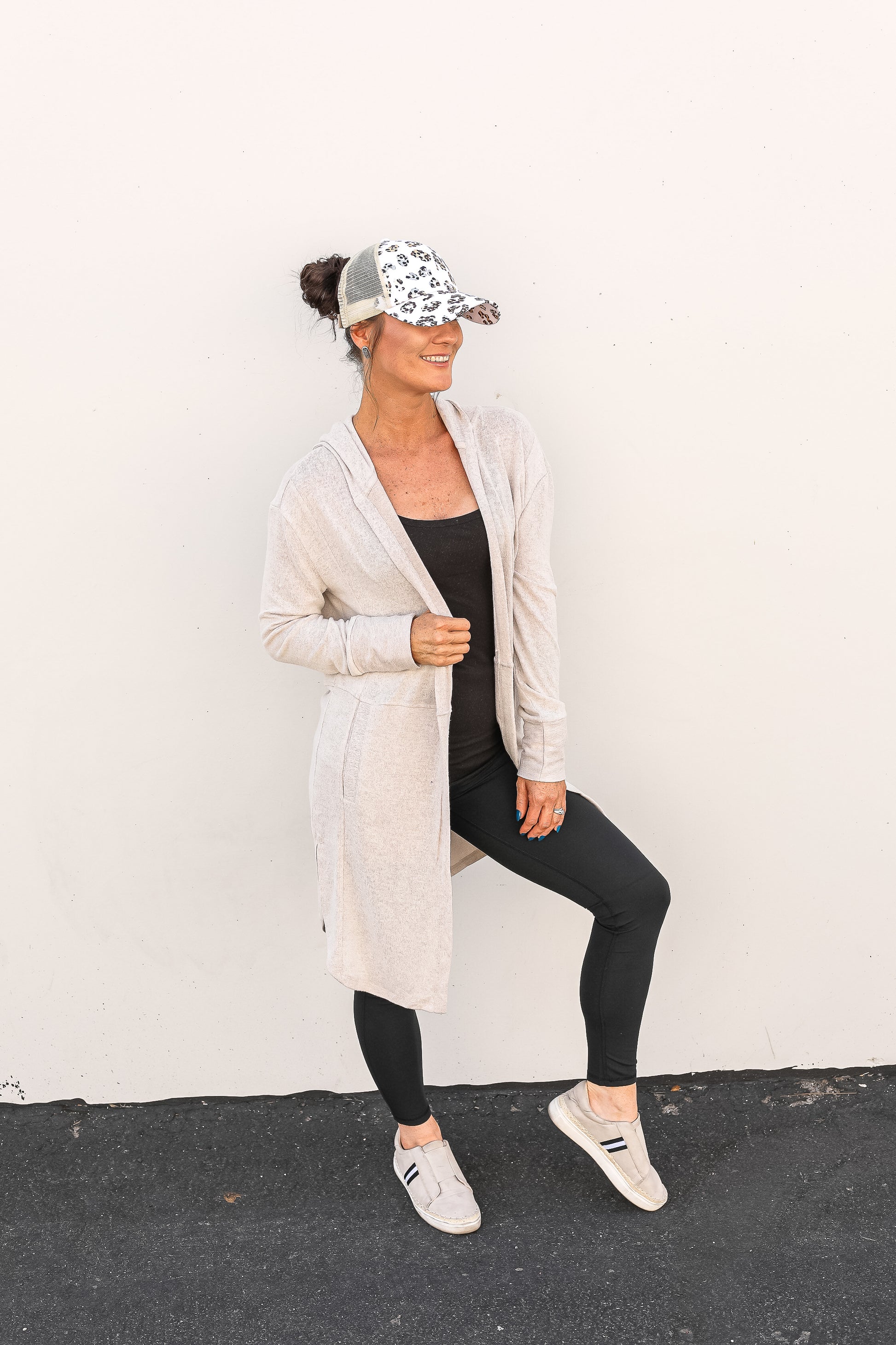Front view of the oatmeal cardigan paired with leggings