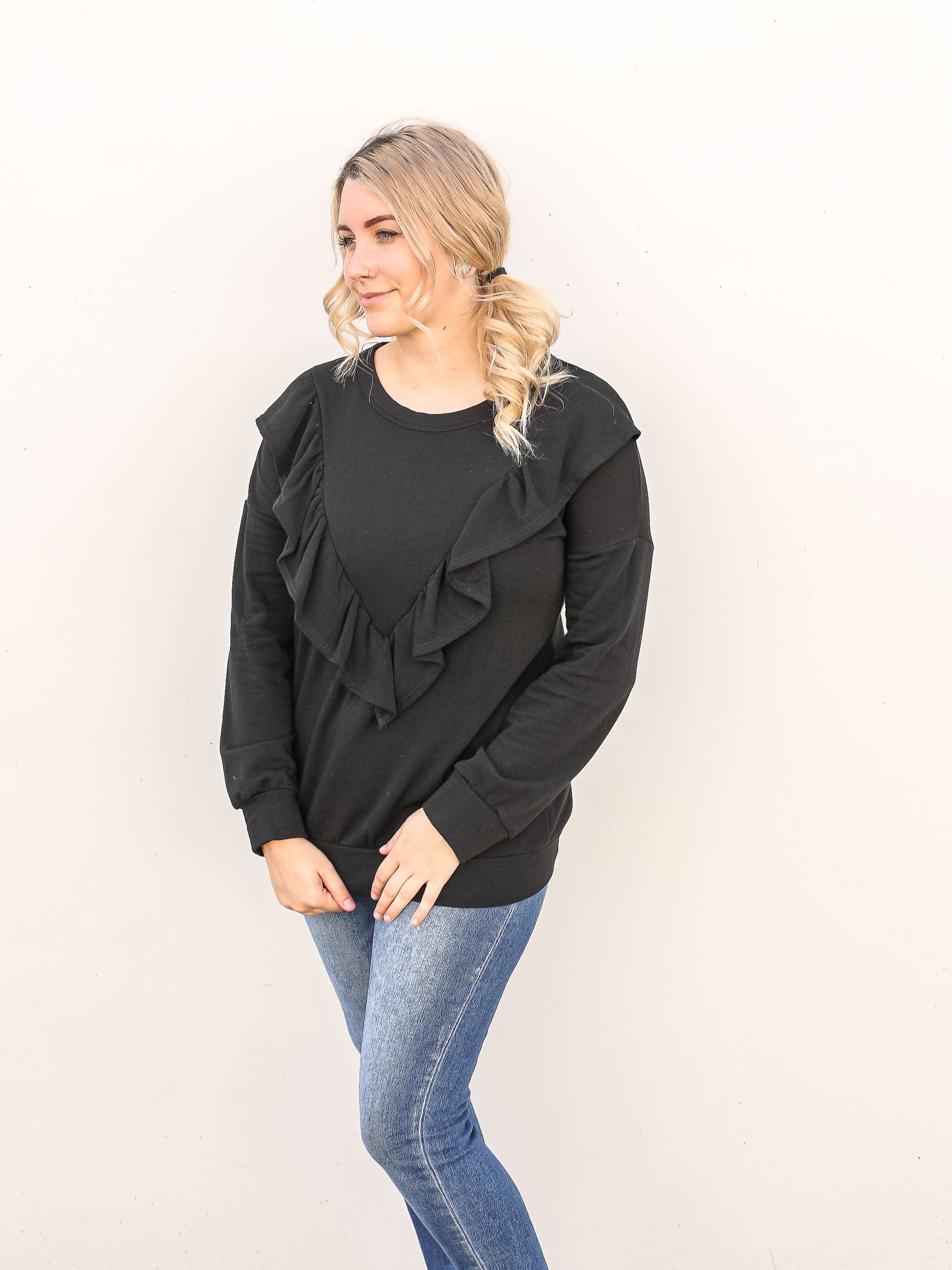 black ruffled top with jeans