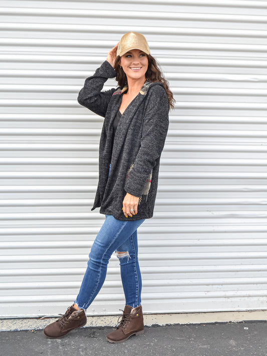 Back and plaid cardigan styled with denim and a gold glitter hat