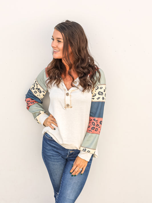 Long sleeve v neck top with animal print and color blocked sleeves